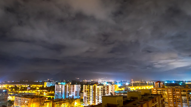 Clouds over a city in the night