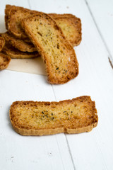 Slice of crostini on white background. A crostino is a small slice of toasted or grilled bread in Italian cuisine (appetizers). A versatile snack to eat plain, with vegetable, cheeses & meats!
