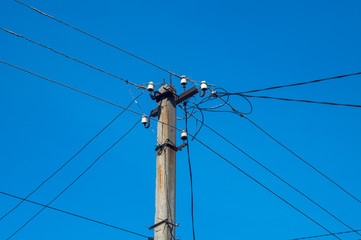 Electric pillar with wires on dark blue sky