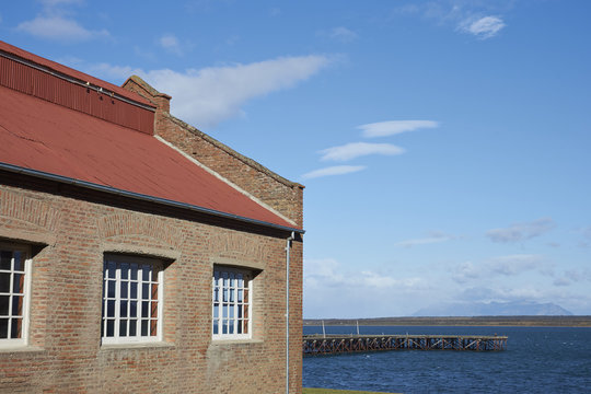 Historic buildings and pier of a former meat refrigeration plant that have been renovated and converted into a luxury hotel.