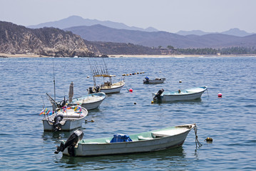 Fototapeta na wymiar Fishing boats anchored in an ocean bay