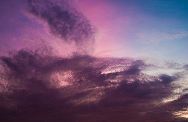 Sunset in violet, orange and blue sky with roof and antenna