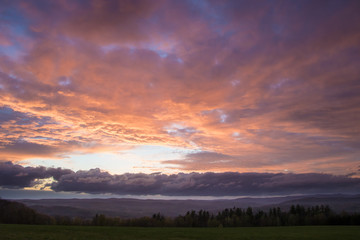 Beautiful Sunset over Meadow with Mountain View
