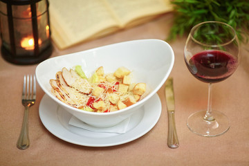 Fresh caesar salad on plate with grilled chicken fillet