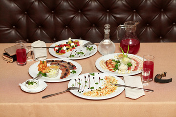 Salad and snacks in restaurant served for two persons