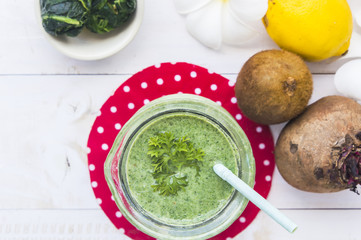 Healthy green smoothie with spinach,kiwi and lemon.