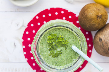 Healthy green smoothie with spinach,kiwi and lemon.