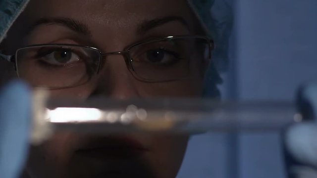 Woman scientist looking at new kind of insect in research laboratory, entomology