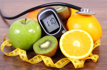 Glucometer, stethoscope, fruits and centimeter, diabetes lifestyles and nutrition