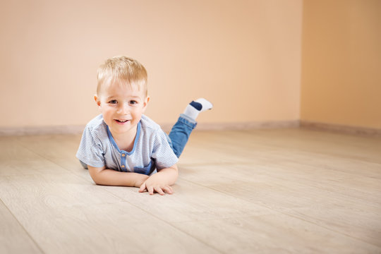 Portrait of a two years old child lying on the floor
