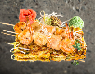 Shrimp salmon skewers on vegetable omelette