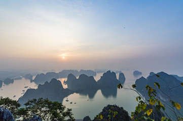 Karst landforms in the sea at the sunrise landscape view from Bai Tho Mountain in Halong Bay, Vietnam, Southeast Asia. UNESCO World Heritage Site