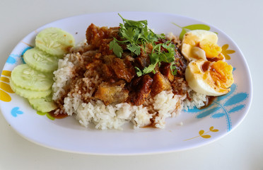 Stewed pork leg with Rice on white table.