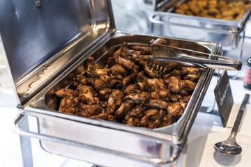 BBQ Chicken wings and nuggets with spicy sauce during a business meeting buffet