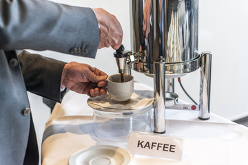 Abstract coffee tea cup with coffee dispenser business people taking one