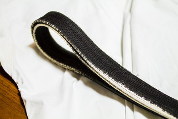 A martial arts master's old Black belt and Gi ( martial arts uniform ) 