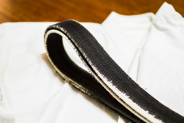 A martial arts master's old Black belt and Gi ( martial arts uniform ) 