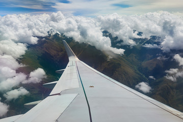 Fototapeta na wymiar Airplane wing under mountain