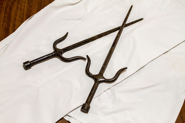A pair of Sai ( traditional okinawan karate's weapon)  on the Gi