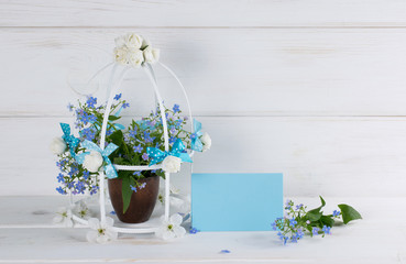 Forget-me-not flowers with birdcage in Shabby Chic style