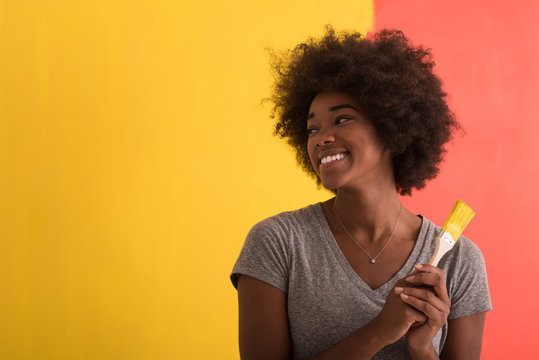 black woman painting wall