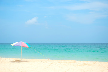 Fototapeta na wymiar Pastels colors umbrella on the white sand beach in Kata beach Phuket Thailand