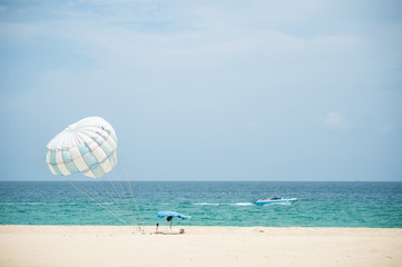 Parasailing on the beach in Karon beach Phuket Thailand, Phuket Beach Sports and Activities. Summer holiday vacation and exotic leisure experience concept. - 149562443