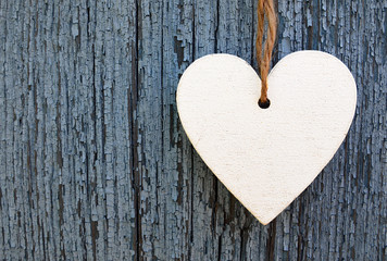 Decorative white wooden heart on blue old wooden background with copy space.Selective focus.Holidays,Love,Valentine's Day concept.