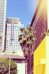 Fototapeten Downtown Los Angeles skyline  with blue sky and palm trees. vertical photo. instagram effect © _nastassia