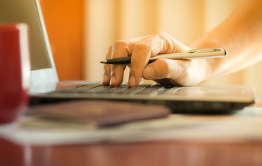business people hands working laptop with holding pen indoor, vintage tone