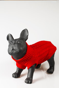 Plastic dog mannequin dressed with red warm sweater