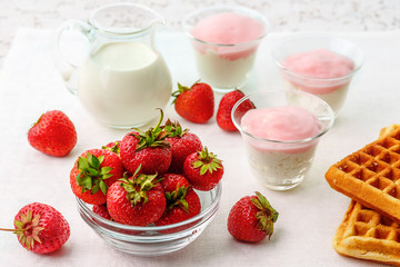 Still life in high key in the form of berries strawberries, biscuits and dairy products.