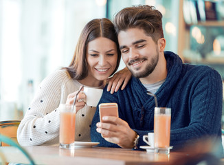 Happy couple enjoying a coffee at the coffee shop
