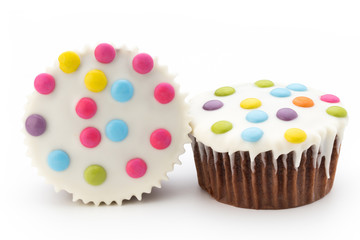 Multiple colorful decorated muffins on a white background.
