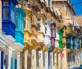 street with colorful balconies in historical part of Valletta in Malta - obrazy, fototapety, plakaty