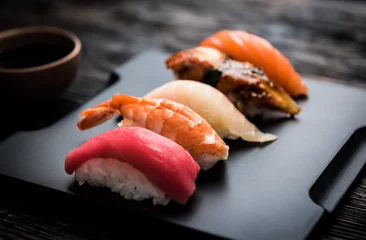 Foto op Plexiglas sashimi sushi set with  soy on black background © Ievgen Skrypko