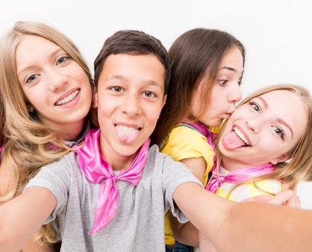 teenage boy making selfie with cute funny girls