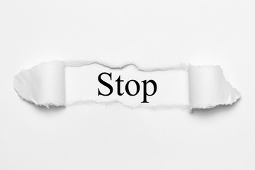 Stop on white torn paper