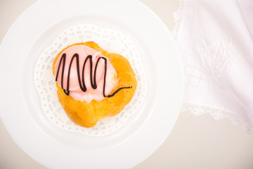 High angle view of a French pastry on white plate and background