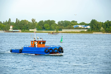 Small tow boat floating on the river