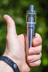 Adult man smoking a vape e-cigarette