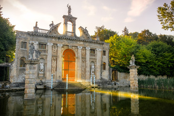 sun rays pass through the gates of Valsanzibio garden on water pond entrance of Villa Barbarigo