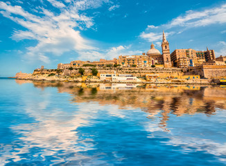 view on Valletta with its architecture from the sea with reflection - obrazy, fototapety, plakaty