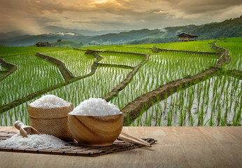 Jasmine rice and steamed rice in wooden bowl with the chopsticks on the wooden table with the...
