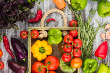 Set of raw vegetables in the wooden tray