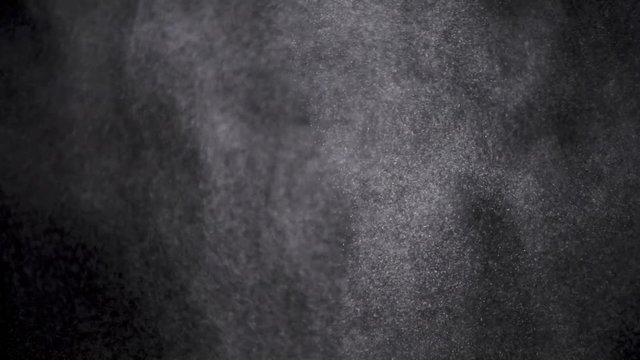 White powder exploding isolated on black