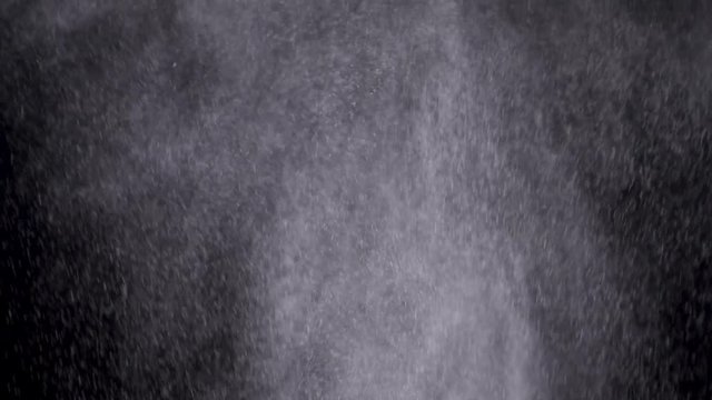 White powder exploding isolated on black