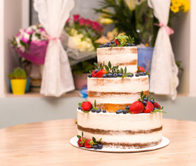Cake with white cream and fresh berries from the forest
