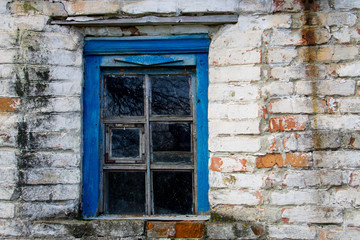 Blue wooden window in old  brick wall