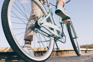 Blue vintage bicycle with white wheels on a sunny summer evening